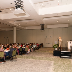 Photo of attendees listening to keynote speaker Wendy Brewer on stage
