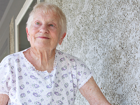 elderly woman standing outside