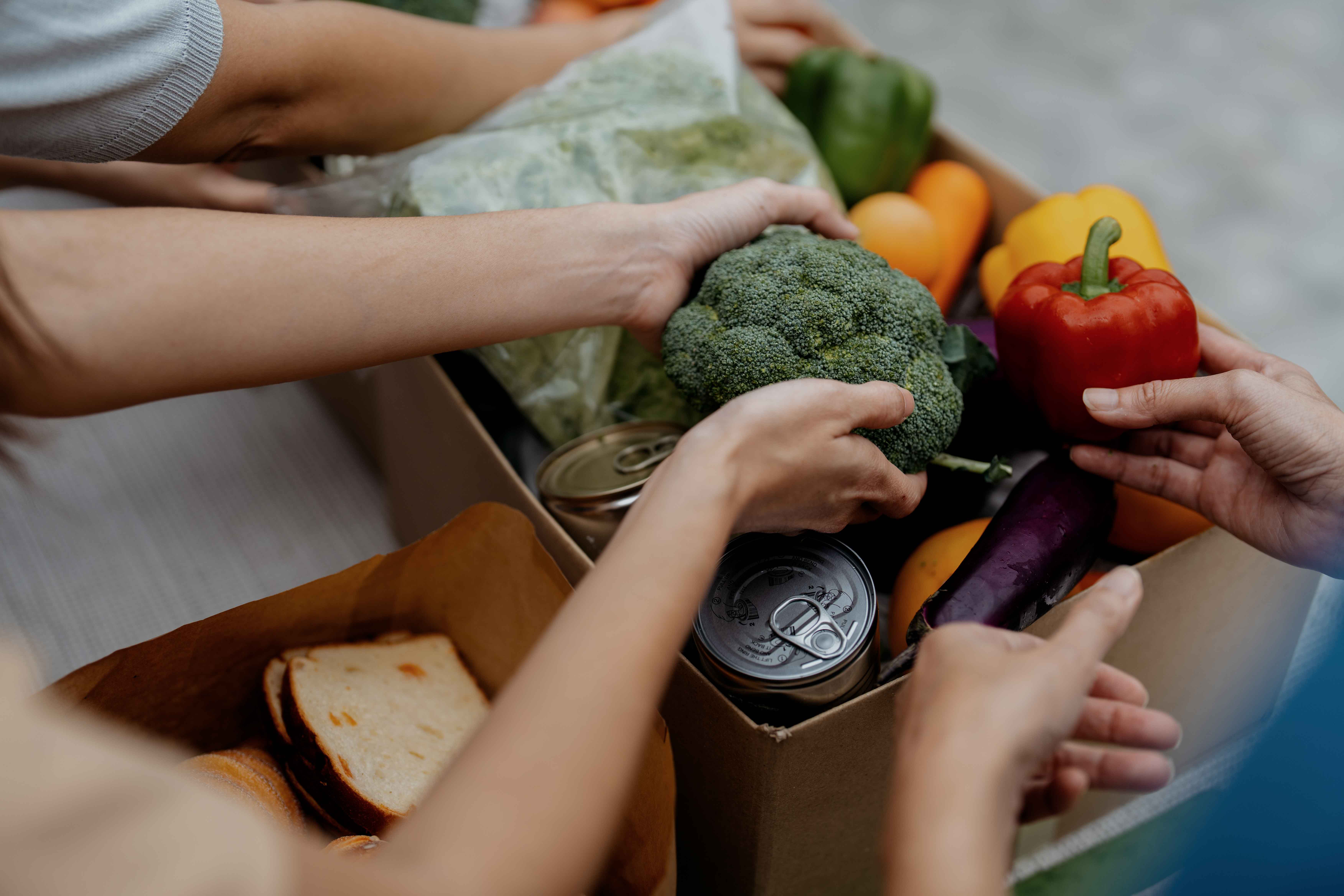 Hands taking produce out of a box