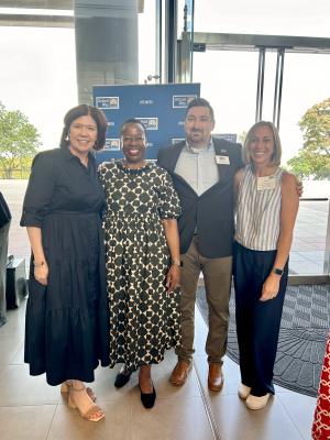 A group of four individuals pose together for the camera. Left to right is Paige Stevenson from United Way of the Piedmont, United Way Worldwide CEO Angela Williams, TUW staff members Director of Strategic Partnerships Joey Current and Director of Advocacy and Public Relations Devon Wade