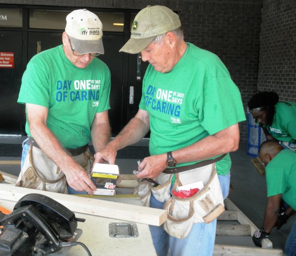 Two volunteers for Days of Caring working on a project