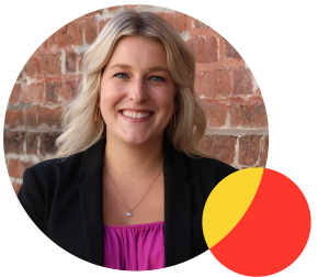 A headshot photo of Staff Attorney Mary Templeton. She is smiling in front of a brick wall.