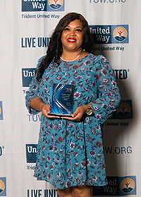 Sonia Hanson holding award