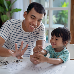 A student and teacher smile together while counting.