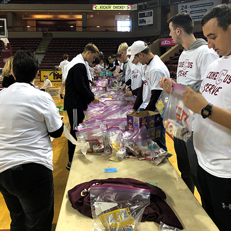 College of Charleston athletes volunteering in the basketball arena