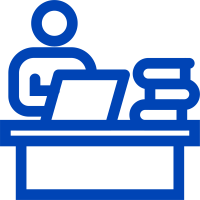 a graphic icon outline of a person working on a computer at a desk with a stack of books