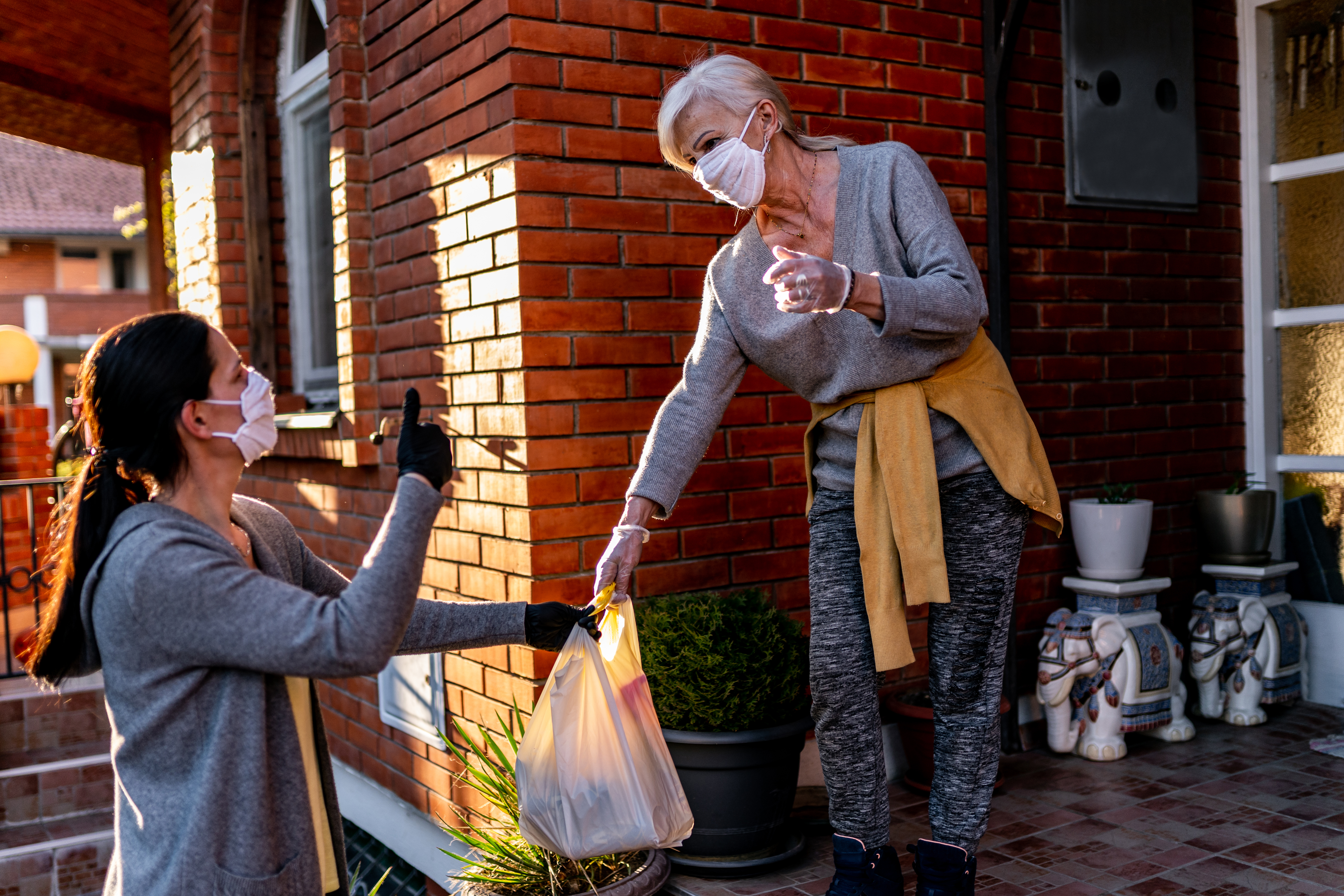 women delivering groceries to another woman