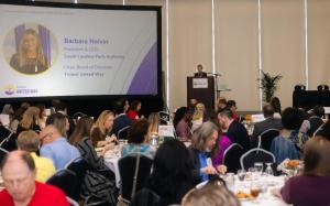 Wide shot of Barbara Melvin speaking on stage at State of Our Families