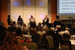 Panel speakers on stage at the Health Symposium