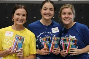 Volunteers holding supplies