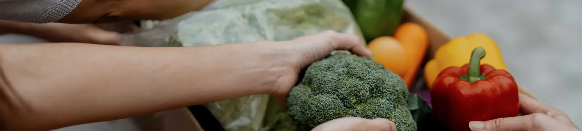 hands taking items out of a food box