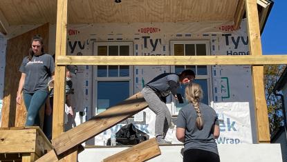 group of volunteers helping to build a house for habitat for humanity