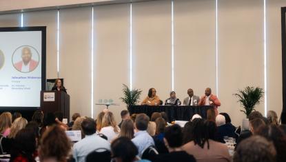 Wide shot of panelists and moderator at State of Our Families