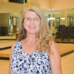 Diabetes Prevention Program Participant posing in empty gym classroom