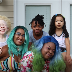 family smiling outside home