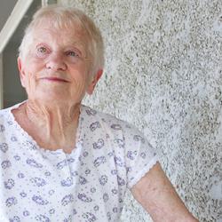 elderly woman standing outside